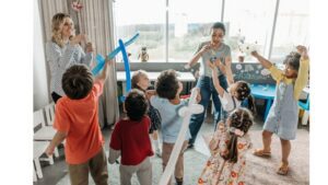 Kids Playing Indoors With Bubbles And Balloon Swords